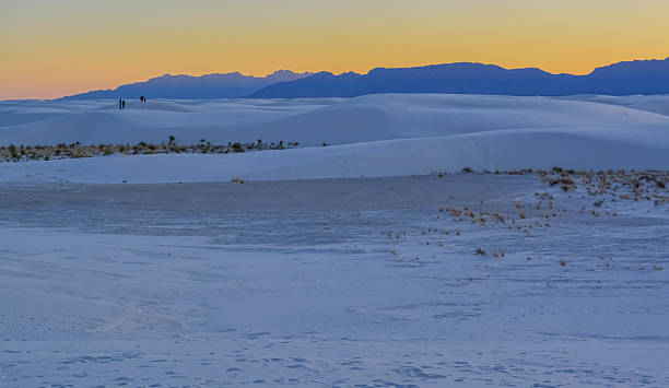 istock Twilight Over White Sands Desert with Distant Hikers, New Mexico 2216147496