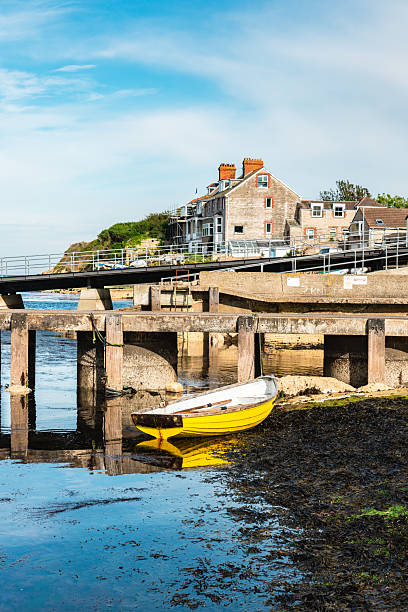 istock Yellow boat resting near swanage pier in dorset 2216149010