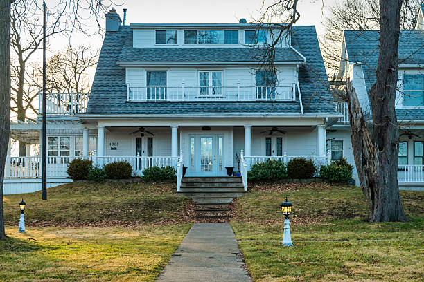 Photo of a white American colonial style home exterior on a bright overcast spring day
