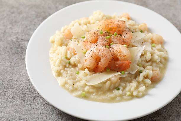 istock Delicious risotto with shrimps and cheese on grey table, closeup 2216152304