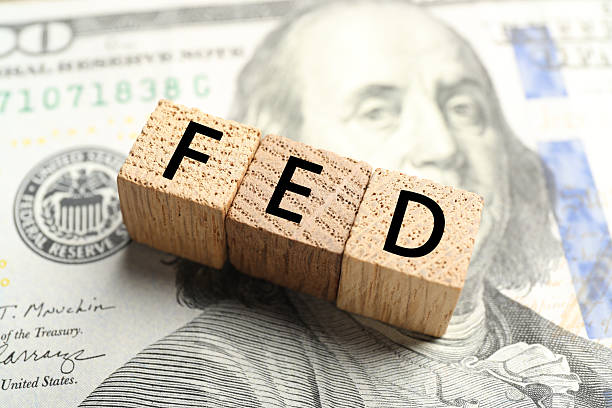 istock Wooden cubes with letters Fed (Federal Reserve System) on dollar banknote, closeup 2216152659