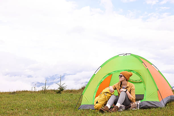 istock Young camper and tent in mountains. Active tourism 2216153011