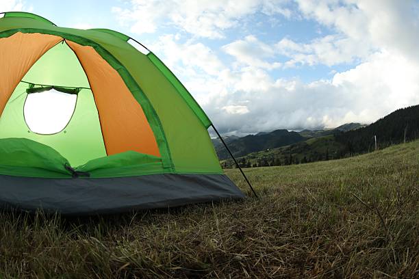 istock Tent on green grass in mountains, space for text 2216153284
