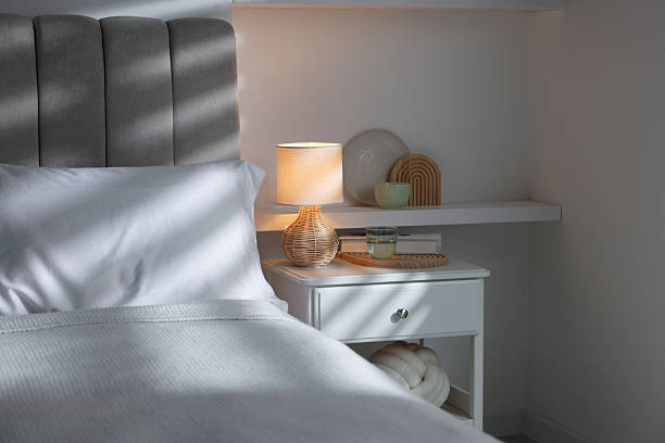istock Stylish living room interior with bed, bedside table and lamp 2216153518