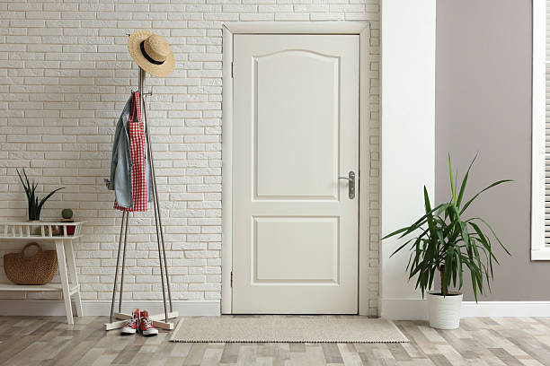 istock Metal rack with clothes and straw hat in hallway 2216153523