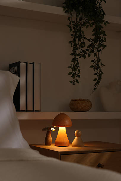 Stylish living room interior with bed, bedside table and night light