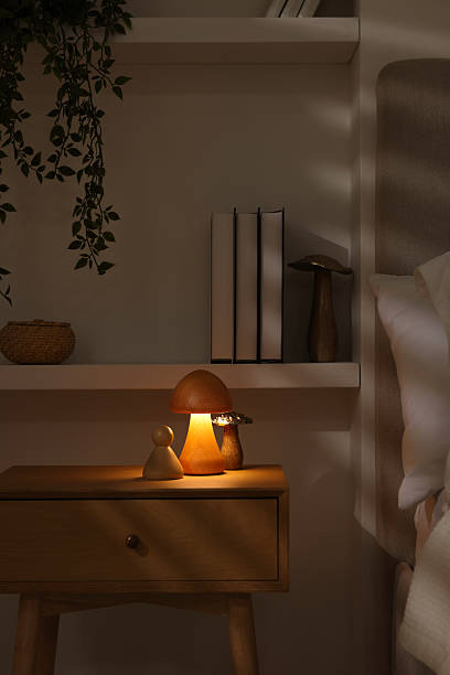 istock Night light on bedside table and other decor in room 2216153546
