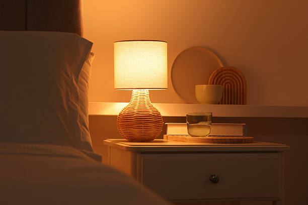 istock Stylish living room interior with bed, bedside table and lamp 2216153548