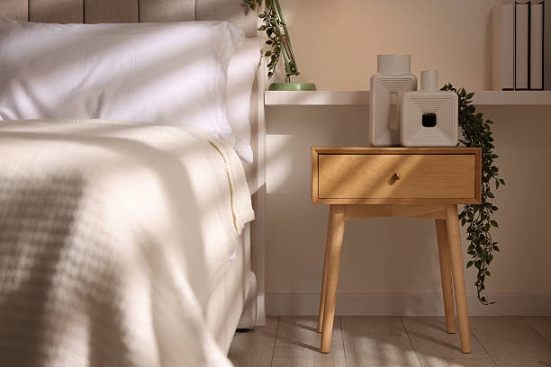 istock Stylish living room interior with bed, bedside table and lamp 2216153554