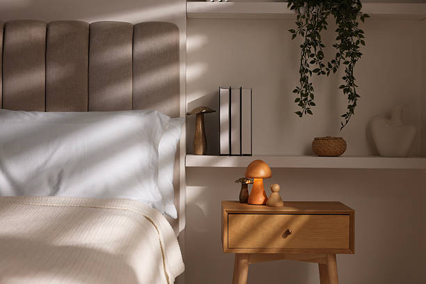 istock Stylish living room interior with bed, bedside table and night light 2216153558