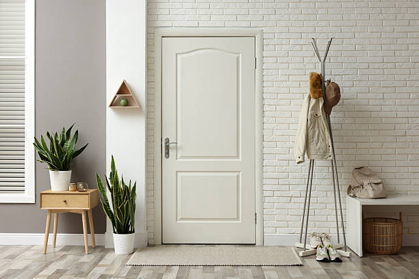 istock Metal rack with jacket, cap and sneakers in hallway 2216153560