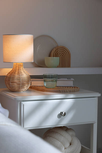 istock Stylish living room interior with bed, bedside table and lamp 2216153562