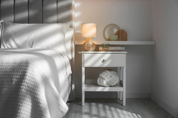 istock Stylish living room interior with bed, bedside table and lamp 2216153565