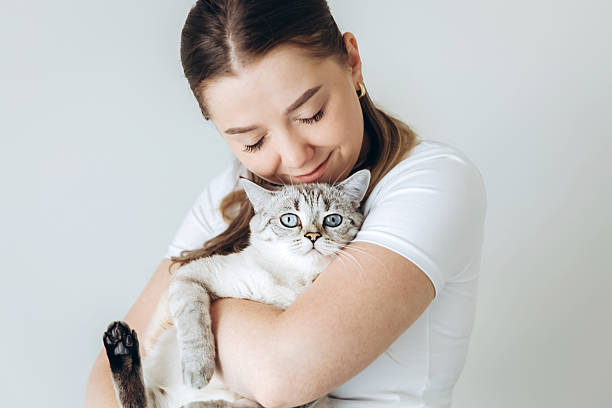 istock Woman hugging cat with gentle peaceful expression 2216156994