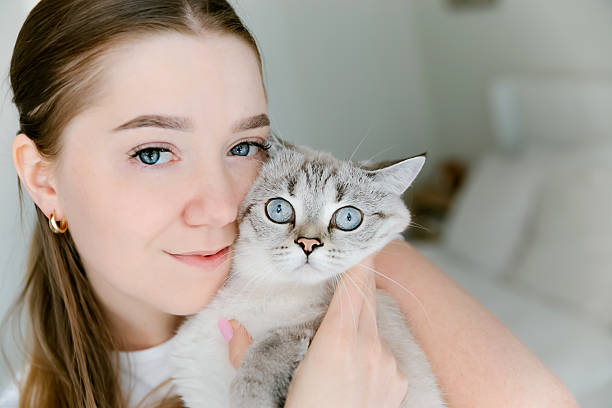 istock Woman embracing cat with affectionate smile, indoors 2216157059