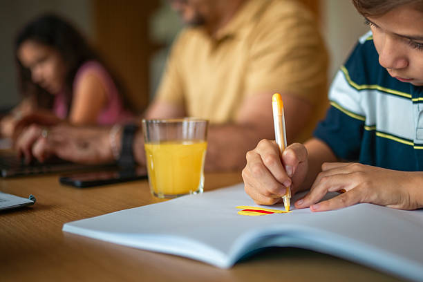 istock Focused Hispanic Father Assisting Children with Homework 2216161344