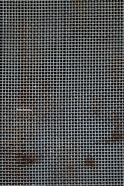 istock Close-up of rusty metal grid with shadowy background 2216162975