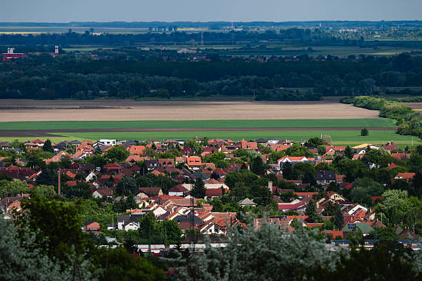 istock Suburban neighborhood with red rooftops and surrounding fields 2216163019