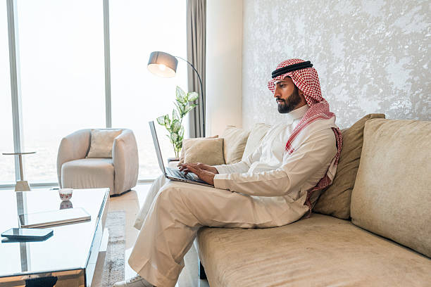 istock Focused Young Arabic Businessman Working on Laptop in Modern Home 2216163407