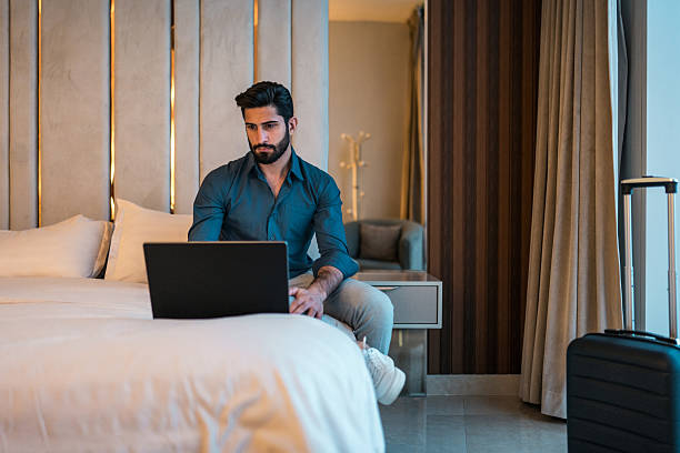istock Focused Middle Eastern Businessman Working in Elegant Hotel Room 2216163425