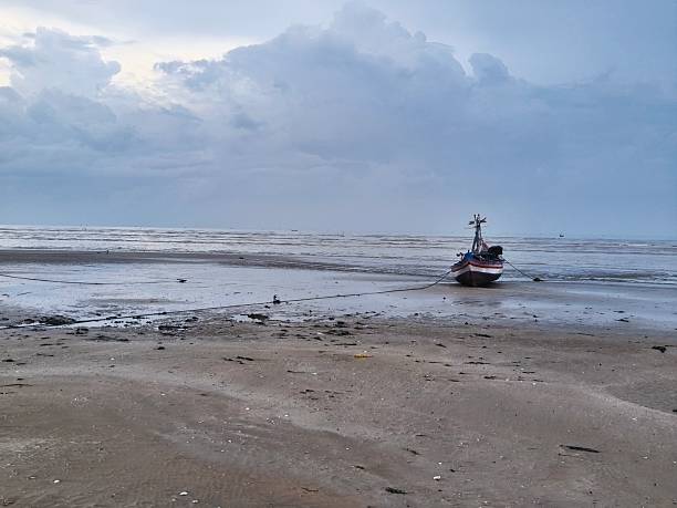 istock fishing boat stranded on the beach after sailing to catch fish 2216165498