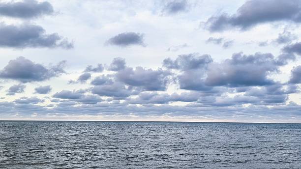 istock gentle sea waves and a blue sky filled with white clouds 2216165509