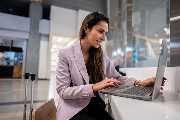 istock Young businesswoman using laptop on airport 2216166355