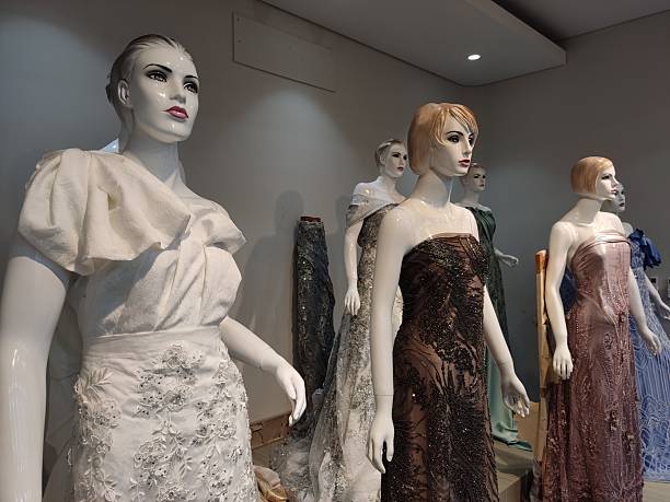 istock Mannequins line up with luxury dresses on display store 2216169541
