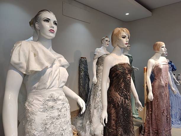 istock Mannequins line up with luxury dresses on display store 2216169625
