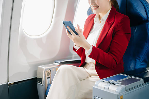 istock Young Asian executive excels in first class, multitasking with digital tablet, laptop and smartphone. Travel in style, work 2216169718