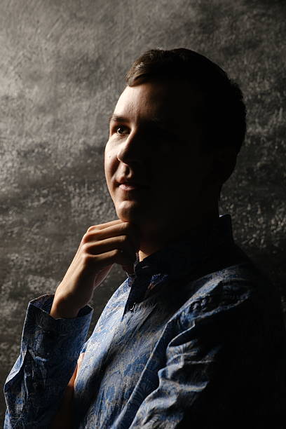 A striking silhouette of a thoughtful young man against a beautifully textured background that draws attention