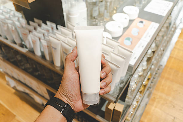 istock Hand Holding Blank Cosmetic Tube in Store. 2216170827