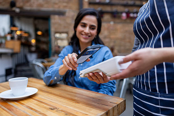 istock Customer paying with her phone at a restaurant 2216170978