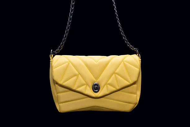 istock Yellow textile women's handbag with a strap on a black background 2216173931
