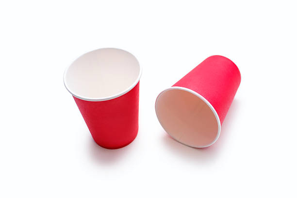 istock Two disposable red cups for coffee and drinks made of cardboard on a white background 2216174059