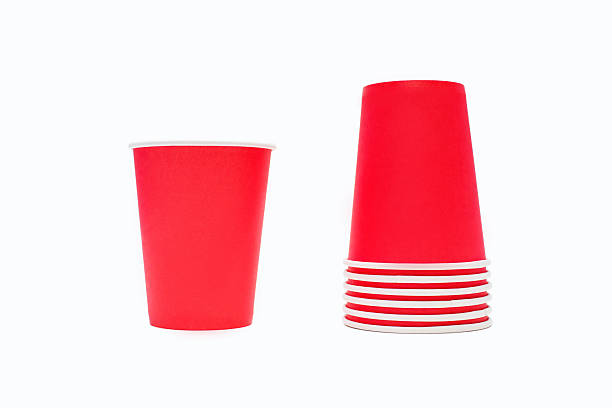 istock Stack of red disposable cardboard coffee cups isolated on white background 2216174113