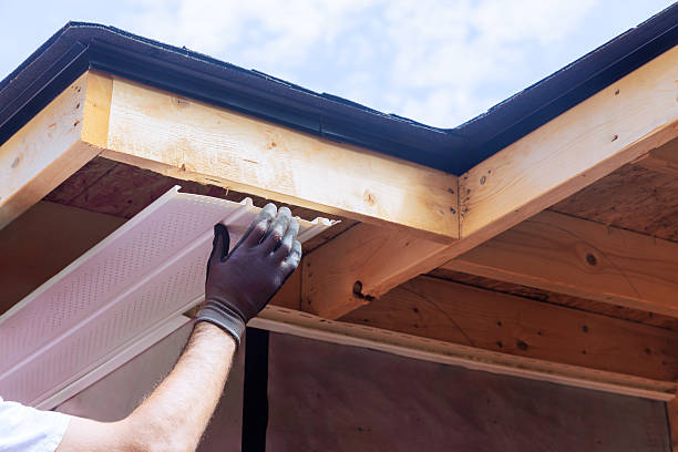 istock Worker installing soffit under eaves on residential building during works day 2216176423