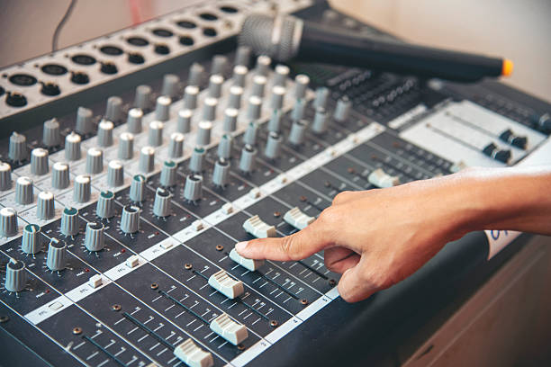 istock Production sound engineer woman hands adjusting volume equalizer voice, mixing console. DJ sound engineering working on recording studio mixing voice control.  Producer remix tune music sound record 2216180024