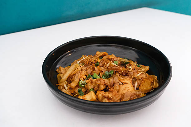 Kwetiaw or Kwetiau, fried rice noodles with meatballs and vegetables.