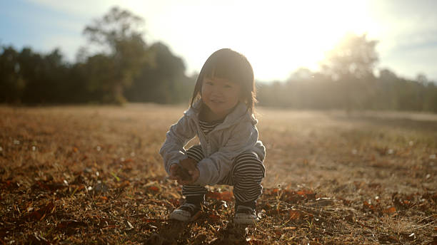 A little child is enjoying herself in her backyard.