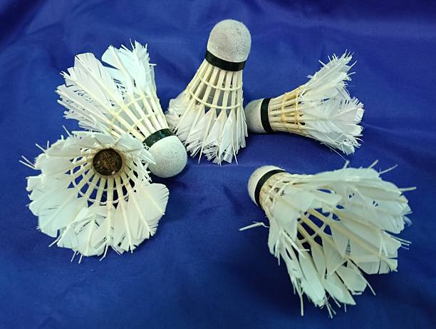 istock worn out or used shuttlecocks on blue background close up. 2216184988