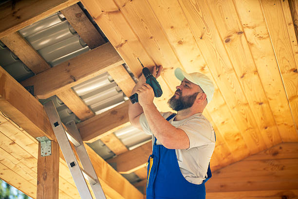istock Worker Using Power Screwdriver for Construction on a Wooden Roof in Bright Daylight 2216187057