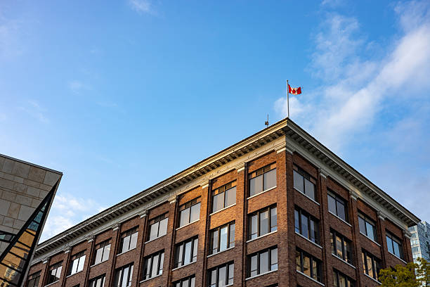 Canada flag on top of a classic building seen from below