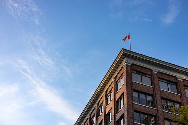 istock Canada flag on top of a classic building seen from below 2216192810