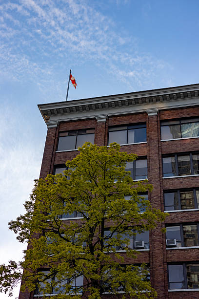 istock Canada flag on top of a classic building seen from below 2216192882