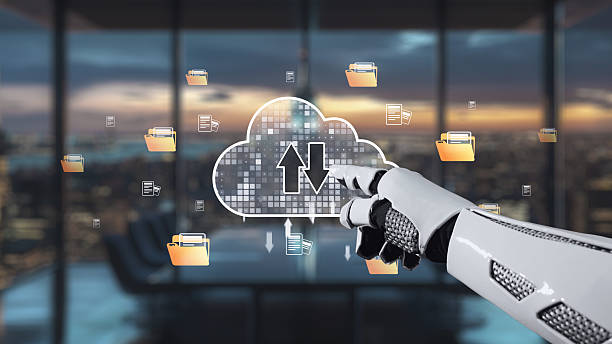 istock Futuristic Robot Hand Pointing at Cloud Storage Icons with Digital Interface in Modern Office Setting at Sunset. Auvana 2216193712