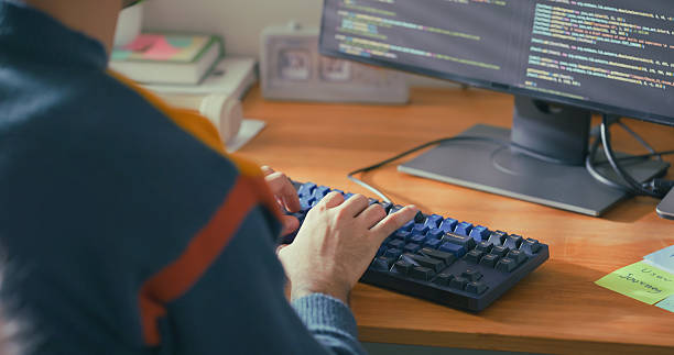 istock Close-up hand typing on a keyboard at a desk in a modern home office. 2216195431