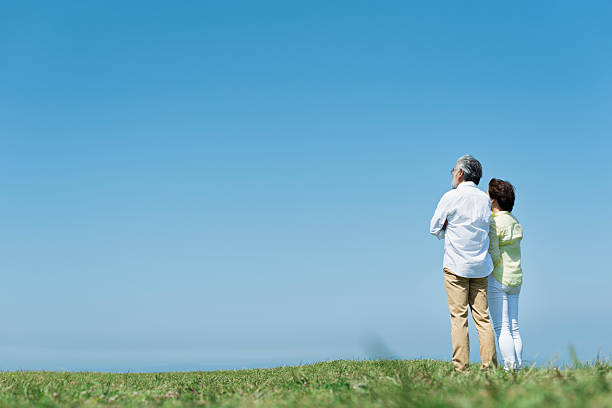 istock Grasslands, blue skies, and a senior couple 2216196691
