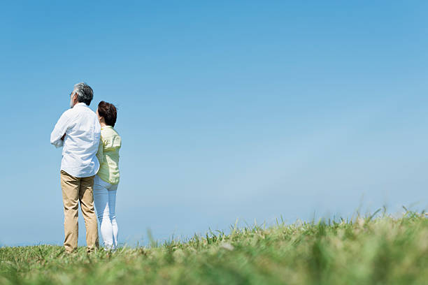 istock Grasslands, blue skies, and a senior couple 2216196910