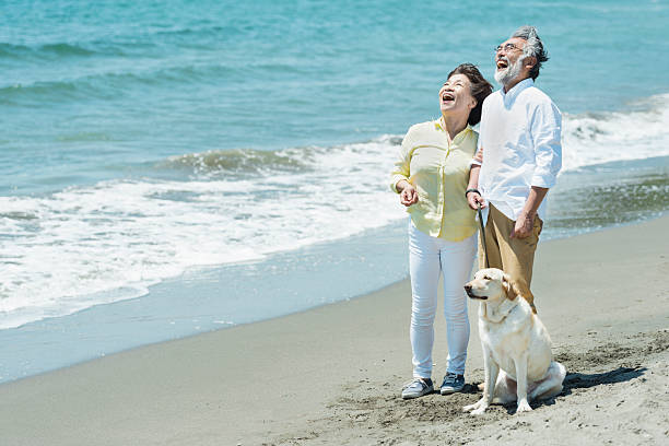 istock Senior couple and dog on the beach 2216198764